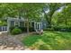 Quaint single-story house featuring mature trees, a well-manicured lawn and a cozy, inviting curb appeal at 1248 Conway Rd, Decatur, GA 30030