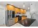 Updated kitchen with stainless steel refrigerator, wooden cabinets and white walls, plus pendant lighting at 1248 Conway Rd, Decatur, GA 30030