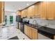 Functional kitchen featuring stainless steel appliances, light wood cabinets, and black countertops at 1248 Conway Rd, Decatur, GA 30030