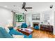 Comfortable living room with a fireplace, hardwood floors, and a large window overlooking the yard at 1248 Conway Rd, Decatur, GA 30030