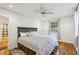 Cozy main bedroom features wood floors, ceiling fan and ensuite bathroom, plus large bed at 1248 Conway Rd, Decatur, GA 30030