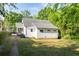 Back exterior view with a lush green lawn and a white painted house at 1575 Linda Sw Way, Atlanta, GA 30310