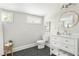 Bathroom features black tiled floors, vanity with storage, and a round mirror at 1575 Linda Sw Way, Atlanta, GA 30310