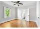 Sunlit bedroom with hardwood floors, neutral walls, and an attached bathroom at 1575 Linda Sw Way, Atlanta, GA 30310