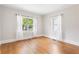 Bright bedroom featuring hardwood floors, two windows, and neutral wall paint at 1575 Linda Sw Way, Atlanta, GA 30310