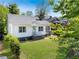 Charming home with light blue door, black trim, and a well-maintained lawn at 1575 Linda Sw Way, Atlanta, GA 30310