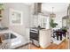 Bright kitchen features granite counters, island seating, stainless appliances and hardwood floors at 1575 Linda Sw Way, Atlanta, GA 30310
