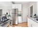 Kitchen area with stainless steel refrigerator, granite counters and sink, and light wood floors at 1575 Linda Sw Way, Atlanta, GA 30310