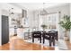 Open kitchen and dining space with modern lighting, stainless appliances, and kitchen island seating at 1575 Linda Sw Way, Atlanta, GA 30310
