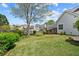 Expansive backyard features green grass, a patio, mature trees, and a fenced perimeter at 1284 Charter Club Ct, Lawrenceville, GA 30043