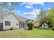 Spacious backyard with a covered patio area with an awning and a storage shed at 1284 Charter Club Ct, Lawrenceville, GA 30043