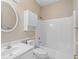 Bright bathroom featuring a white vanity, toilet, and bathtub with shower, plus built-in wall cabinet at 1284 Charter Club Ct, Lawrenceville, GA 30043