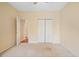 Neutral bedroom with carpet, ceiling fan, and a closet and entry to another room at 1284 Charter Club Ct, Lawrenceville, GA 30043