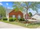 Brick home with lush landscaping and a well-kept lawn. A charming residence at 1284 Charter Club Ct, Lawrenceville, GA 30043