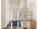 Inviting foyer with hardwood floors, soaring ceilings, elegant lighting, and an arched window at 1284 Charter Club Ct, Lawrenceville, GA 30043