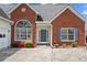 Welcoming brick home featuring a large front window, well-maintained garden, and classic design at 1284 Charter Club Ct, Lawrenceville, GA 30043