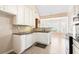 Bright kitchen features granite countertops and white cabinetry, offering ample storage and a modern design at 1284 Charter Club Ct, Lawrenceville, GA 30043