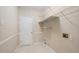 Functional laundry area with overhead shelving and neutral wall color at 1284 Charter Club Ct, Lawrenceville, GA 30043