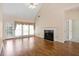 Bright and airy living room featuring a fireplace, tall windows, and hardwood floors at 1284 Charter Club Ct, Lawrenceville, GA 30043