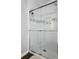 Clean bathroom shower with sleek sliding glass doors, white subway tile and shampoo niche at 1611 Belmont Sw Ave, Atlanta, GA 30310