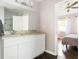 Bright bathroom featuring a double vanity with granite countertops, and neutral paint at 1611 Belmont Sw Ave, Atlanta, GA 30310