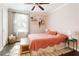 Cozy bedroom featuring warm pink walls, natural light, and decor details on floating shelves at 1611 Belmont Sw Ave, Atlanta, GA 30310