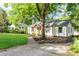 Well-maintained home features a neatly manicured lawn and mature trees offering shade at 1611 Belmont Sw Ave, Atlanta, GA 30310