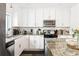 Modern kitchen with stainless steel appliances, white cabinets, granite countertops, and dark hardwood floors at 1611 Belmont Sw Ave, Atlanta, GA 30310