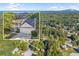 Aerial view showcasing the home, the trees and the surrounding neighborhood at 5223 Hollyfield Dr, Stone Mountain, GA 30088