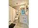 Bathroom featuring tiled floors, white vanity and shower with curtain at 5223 Hollyfield Dr, Stone Mountain, GA 30088