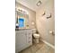 Cozy half bathroom featuring a tiled floor, single sink vanity and neutral paint at 5223 Hollyfield Dr, Stone Mountain, GA 30088