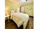 Cozy bedroom featuring a queen bed, wood floors, and bright, neutral walls and décor at 5223 Hollyfield Dr, Stone Mountain, GA 30088