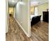 Hallway view of a bedroom with hardwood floors, neutral walls and white trim at 5223 Hollyfield Dr, Stone Mountain, GA 30088