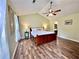 Light-filled bedroom with sloped ceiling, ceiling fan and hardwood flooring at 5223 Hollyfield Dr, Stone Mountain, GA 30088