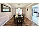 Elegant dining room boasts wood-look flooring, stylish furnishings, and ample natural light for enjoyable meals at 5223 Hollyfield Dr, Stone Mountain, GA 30088