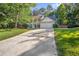 Traditional two-story home with a spacious driveway and well-manicured front lawn at 5223 Hollyfield Dr, Stone Mountain, GA 30088