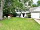 Charming two-story home with a well-manicured lawn and a welcoming front porch at 5223 Hollyfield Dr, Stone Mountain, GA 30088