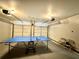 Spacious game room with a ping pong table and bright lights, great for recreation at 5223 Hollyfield Dr, Stone Mountain, GA 30088