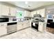 Updated kitchen showcases white cabinets, stainless steel appliances, and sleek countertops, ready for culinary adventures at 5223 Hollyfield Dr, Stone Mountain, GA 30088