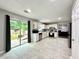 Well-lit kitchen with stainless steel appliances, white cabinetry, and a sliding glass door to the backyard at 5223 Hollyfield Dr, Stone Mountain, GA 30088