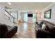 Spacious living room offers wood-look flooring, natural light, and modern finishes, creating a welcoming space at 5223 Hollyfield Dr, Stone Mountain, GA 30088