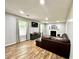 Comfortable living area features a fireplace, mounted TV, modern flooring, and a relaxing seating arrangement at 5223 Hollyfield Dr, Stone Mountain, GA 30088