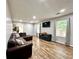 Spacious living room with wood floors, modern fixtures, and a comfortable leather sofa sectional at 5223 Hollyfield Dr, Stone Mountain, GA 30088
