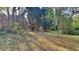 Sloping backyard with lots of green space and shady trees at 1206 Kern Cv, Mcdonough, GA 30253