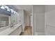 This bathroom features a large vanity, shower and tub, and laminate floors at 1206 Kern Cv, Mcdonough, GA 30253