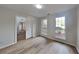 Bright bedroom featuring hardwood floors, neutral paint, and natural light from the large windows at 1206 Kern Cv, Mcdonough, GA 30253