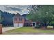 Charming two-story brick home with well-manicured lawn, two-car garage, and mature trees at 1206 Kern Cv, Mcdonough, GA 30253