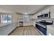 Modern kitchen features white cabinets, stainless steel appliances, and plenty of counter space at 1206 Kern Cv, Mcdonough, GA 30253