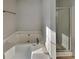 Bathroom featuring soaking tub with jets and glass shower enclosure at 1206 Kern Cv, Mcdonough, GA 30253