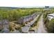 Townhome community surrounded by lush green forests with winding roads and meticulous landscaping at 126 Abbington River Ln, Atlanta, GA 30339